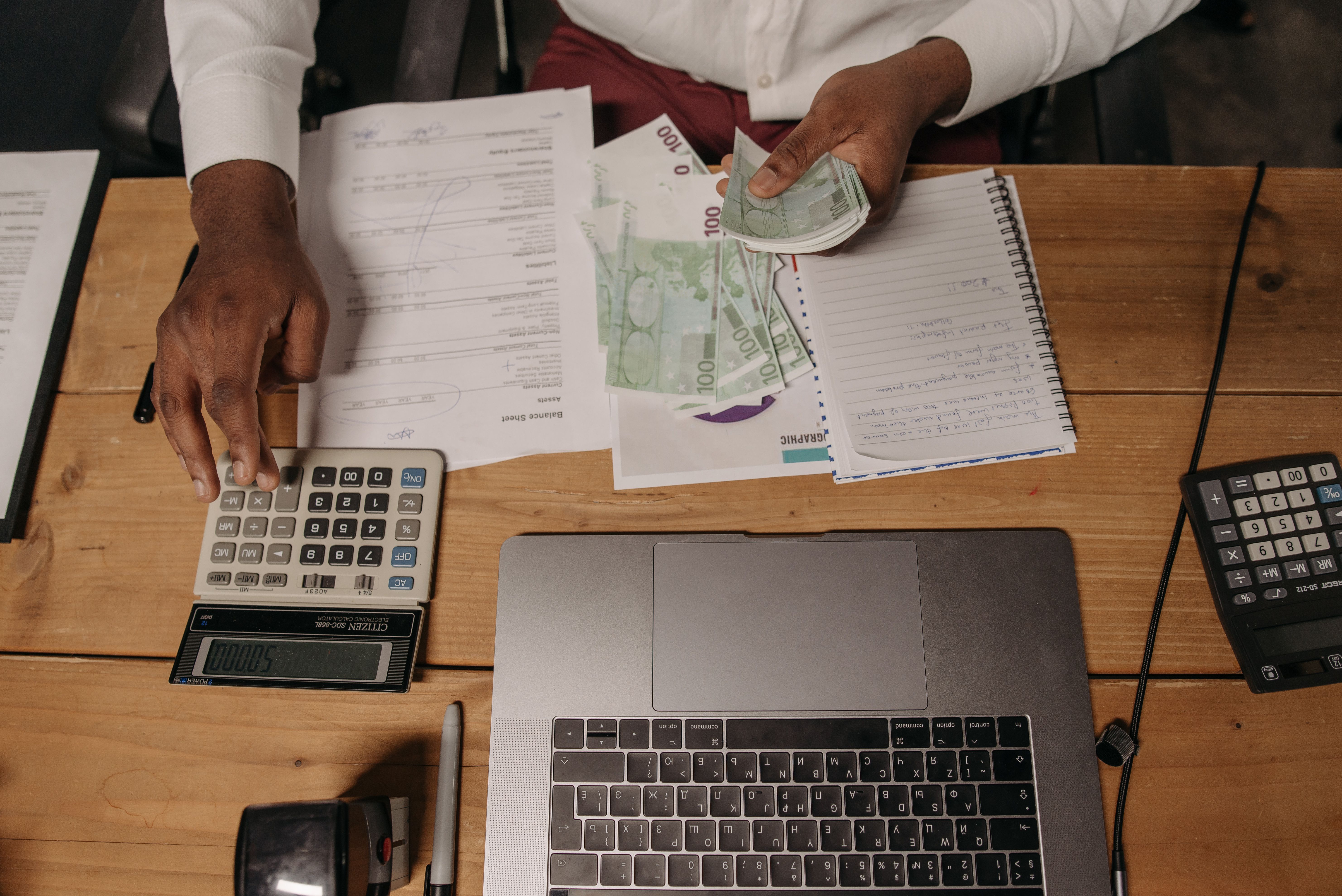Tax working desk with calculator and balance sheet